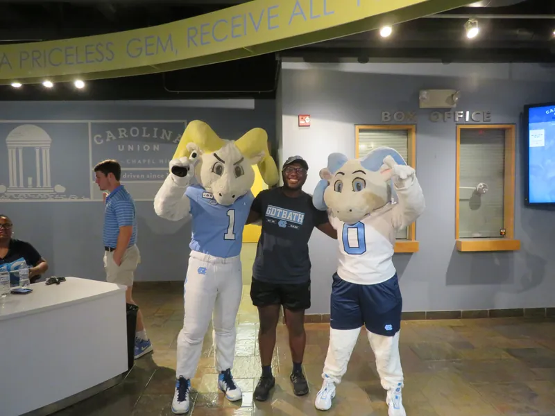 Friends posing with UNC mascots