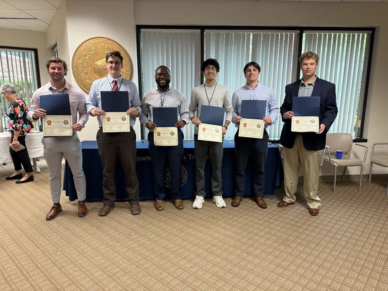 A student cohort holding certificates