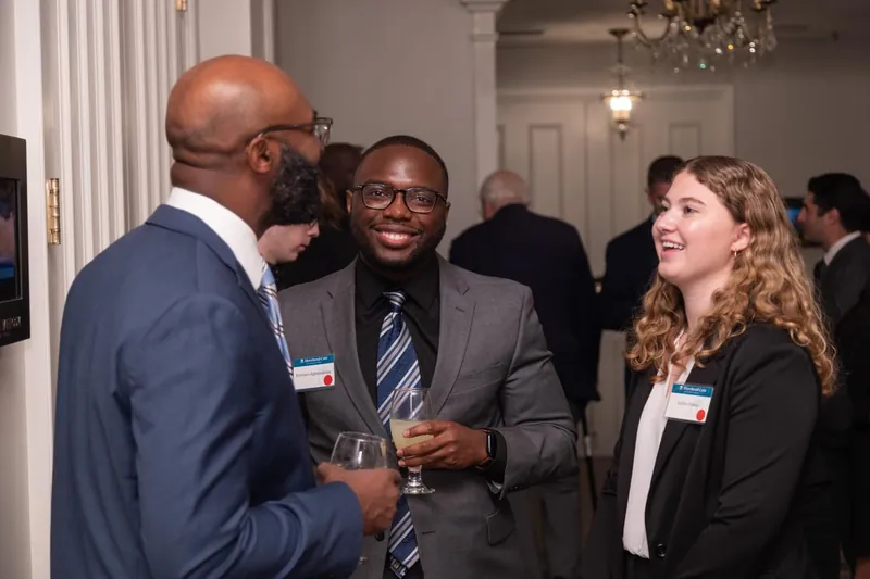 Etornam speaking with guests at a networking event
